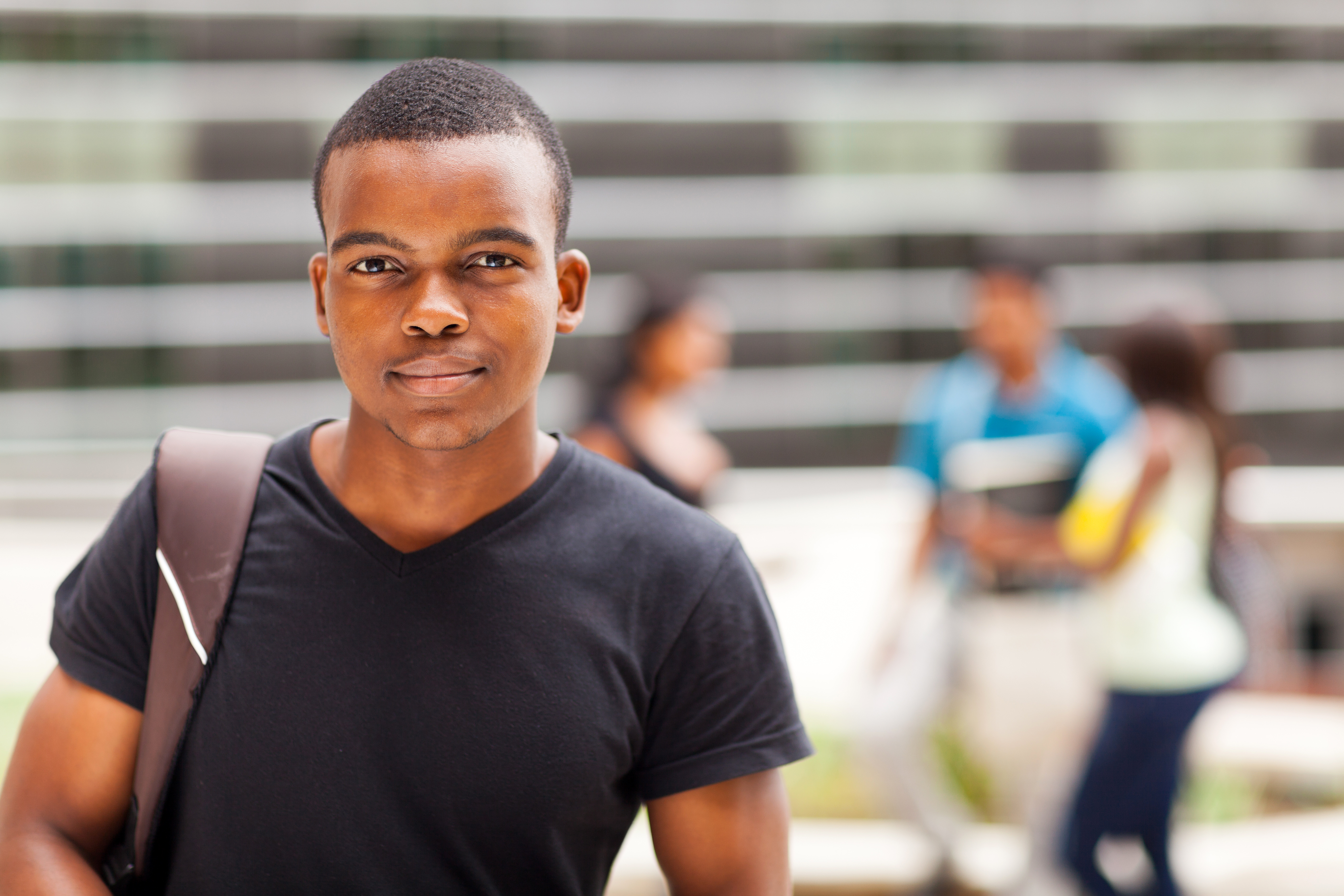 african american college boy standing outdoors