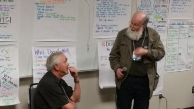 Two men discuss their Person Centered Plan