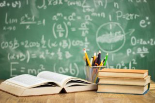 School books on desk, education concept