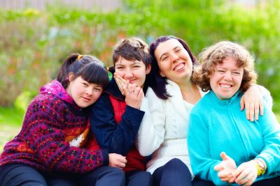 group of happy women with disability having fun in spring park