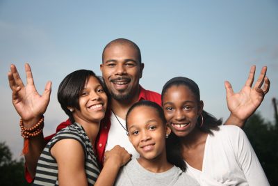 Happy African American family. Father with three teenage daughters together having a good time.