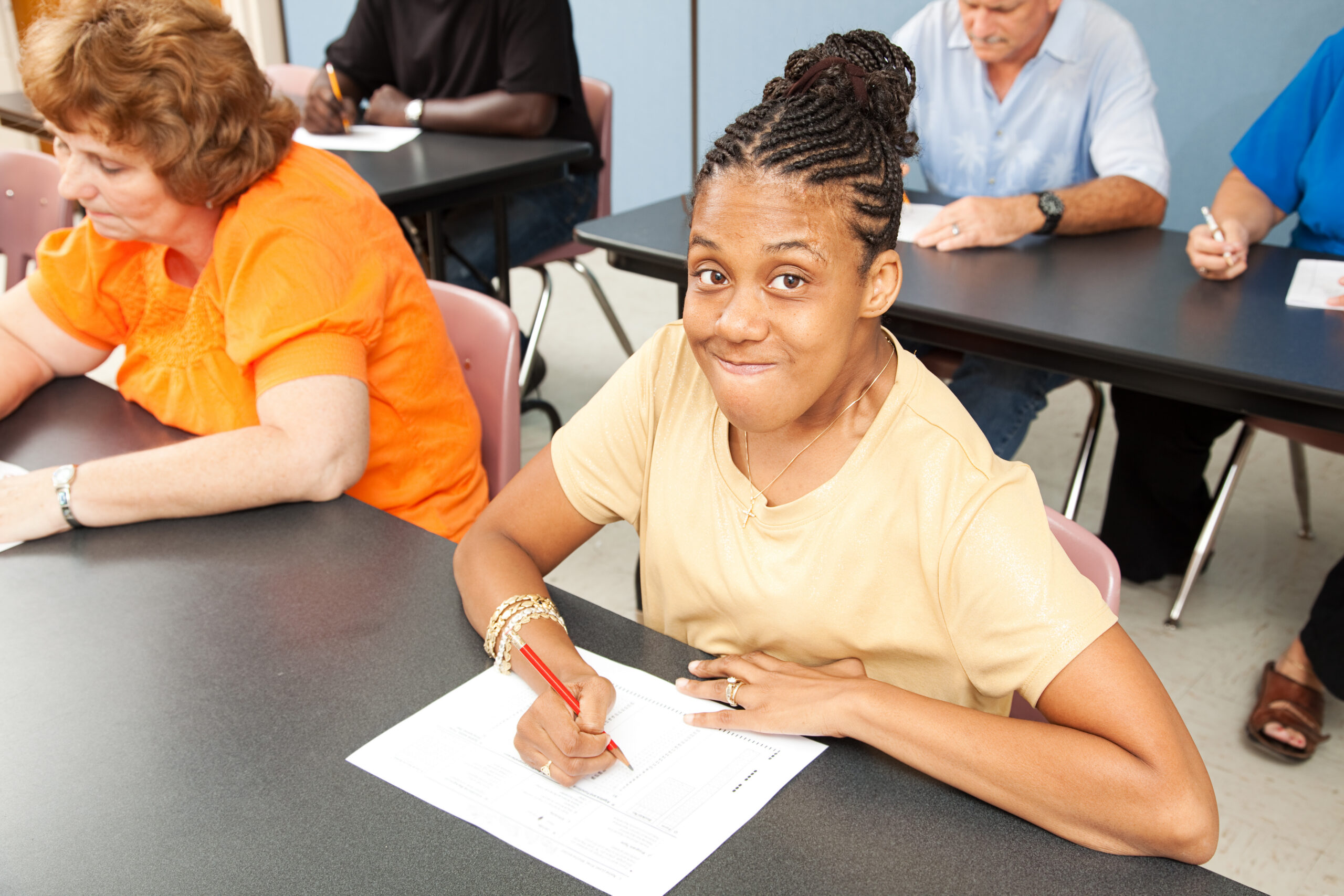 Young woman with cerebral palsy in college class.
