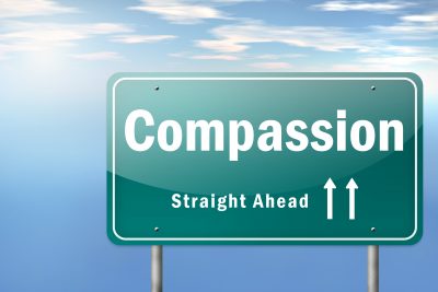 Highway Signpost "Compassion - Straight Ahead"