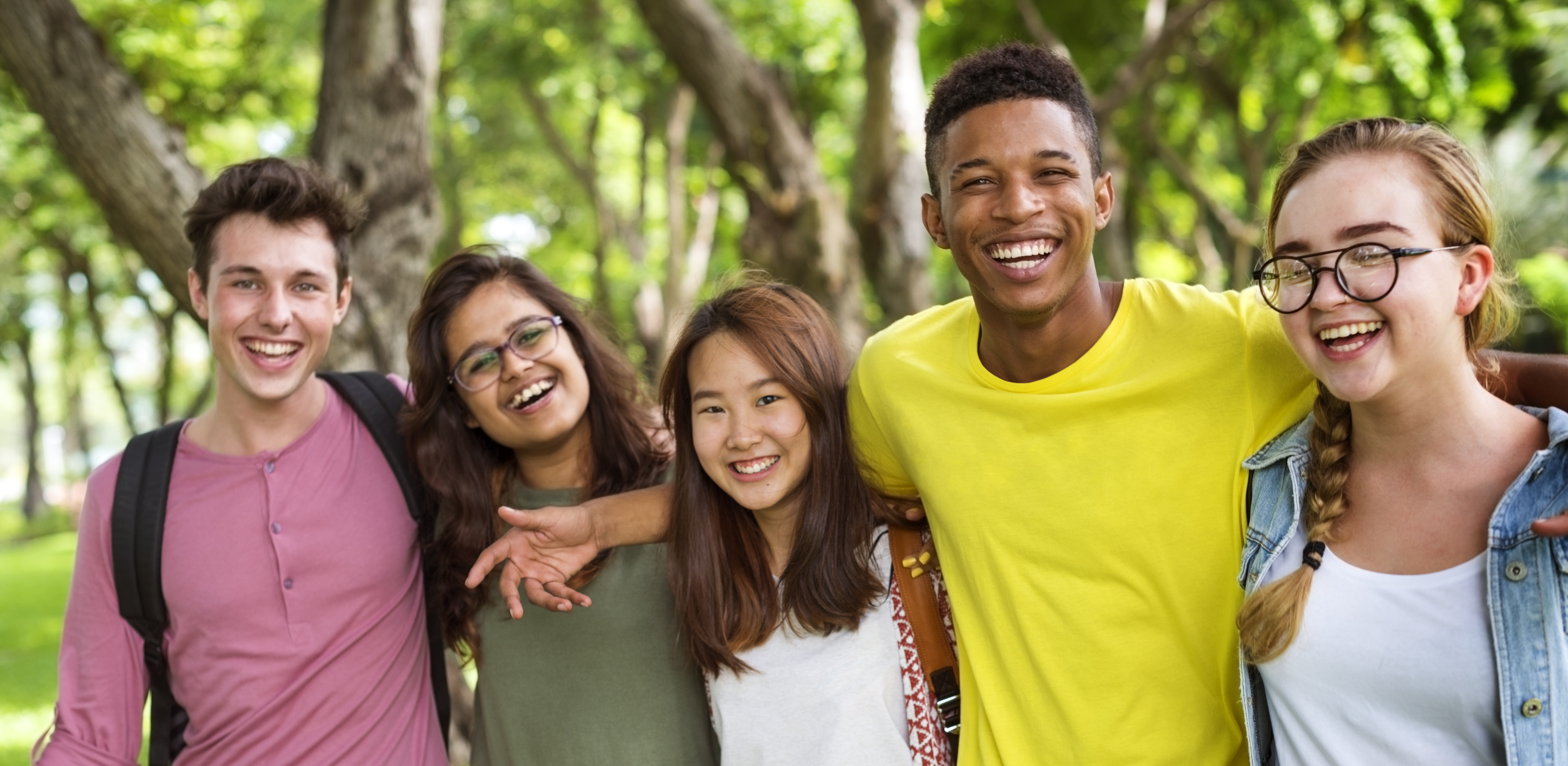 A group of Teenagers are posing and smiling