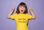 Little girl smiles and poses with the shirt that says I am the I in IEP