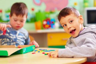 Child smiling playing with a puzzle