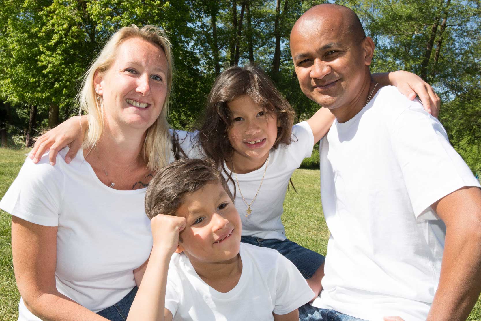 Diverse family poses smiling at the camera
