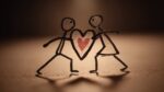 Two stick figures hold a heart symbolizing support