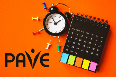 black analog alarm clock , opened calendar with paper tag and multi color thumbtacks on grunge orange paper background, top view