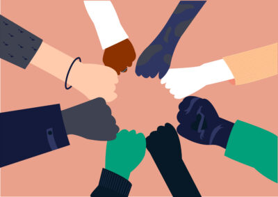 Different colored hands united to signify togetherness