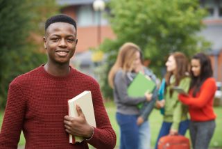 Portrait Of Student Group Outside College Building