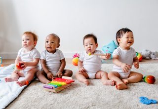 Babies playing together in a play room