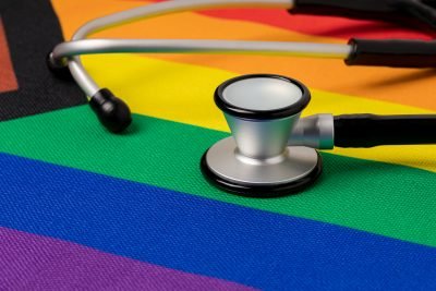 Rainbow pride flag and stethoscope. Transgender and LGBTQ+ health