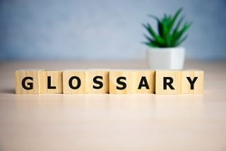 Glossary word made of square letter word on blue background.