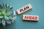 Plan ahead symbol. Wooden blocks with words Plan ahead. Beautiful grey green background with succulent plant. Business and Plan ahead concept. Copy space.