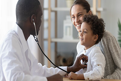 African male pediatrician hold stethoscope exam child boy patient visit doctor with mother, black pediatrician check heart lungs of kid