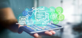 View of a Businessman holding a cloud of social media network icon