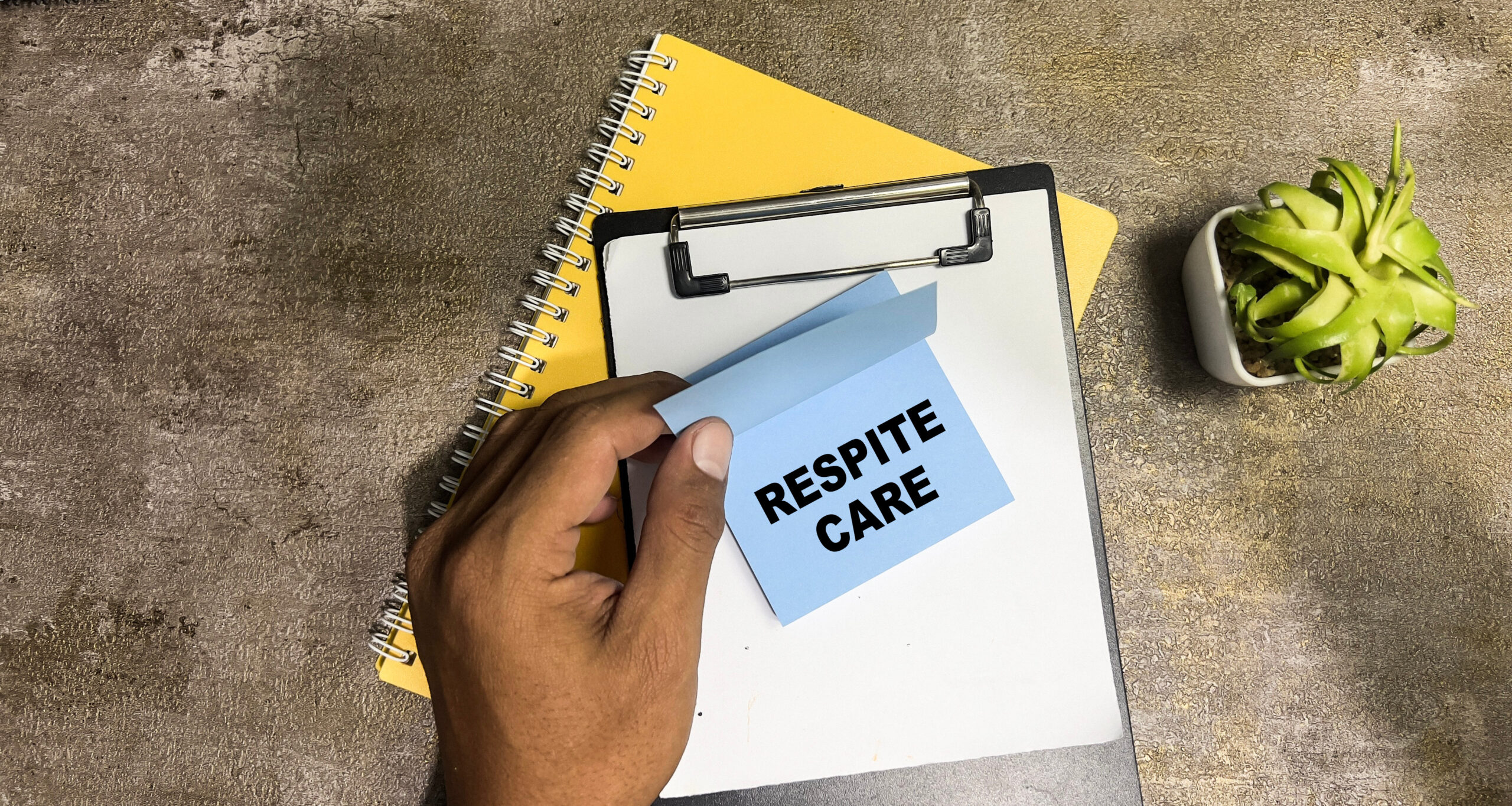 Concept of Respite Care write on sticky notes isolated on Wooden Table.