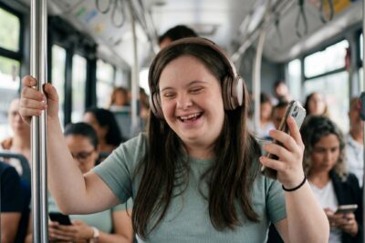 Girl with Down Syndrome listening to music while riding a bus