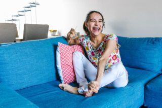 latin teen girl with cerebral palsy sitting on the couch relaxed and smiling
