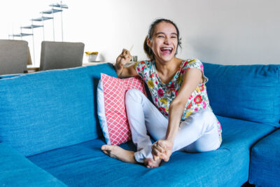 latin teen girl with cerebral palsy sitting on the couch relaxed and smiling