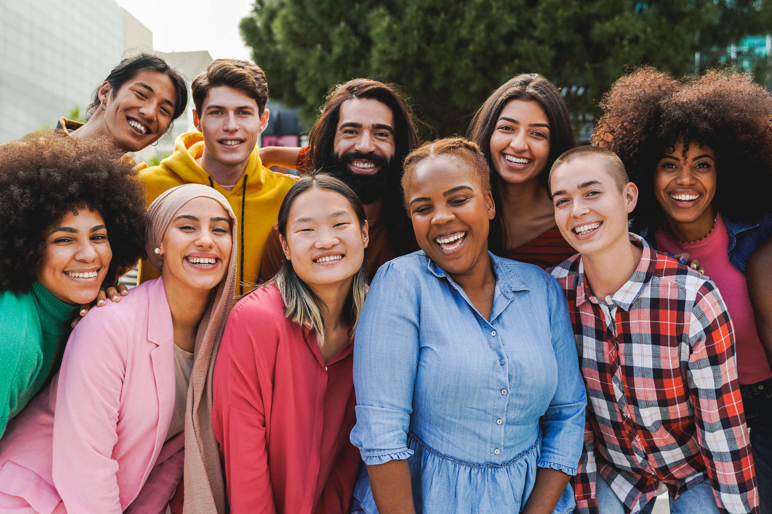 group of diverse young adults standing in 2 rows
