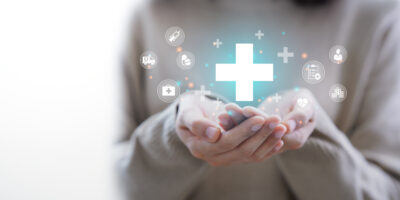 Woman hand holding plus icon for the healthcare medical icon. Health insurance health concept.