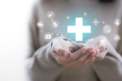 Woman hand holding plus icon for the healthcare medical icon. Health insurance health concept.