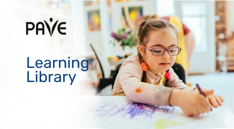 An elementary school aged girl with down syndrome coloring with the words PAVE Learning Library